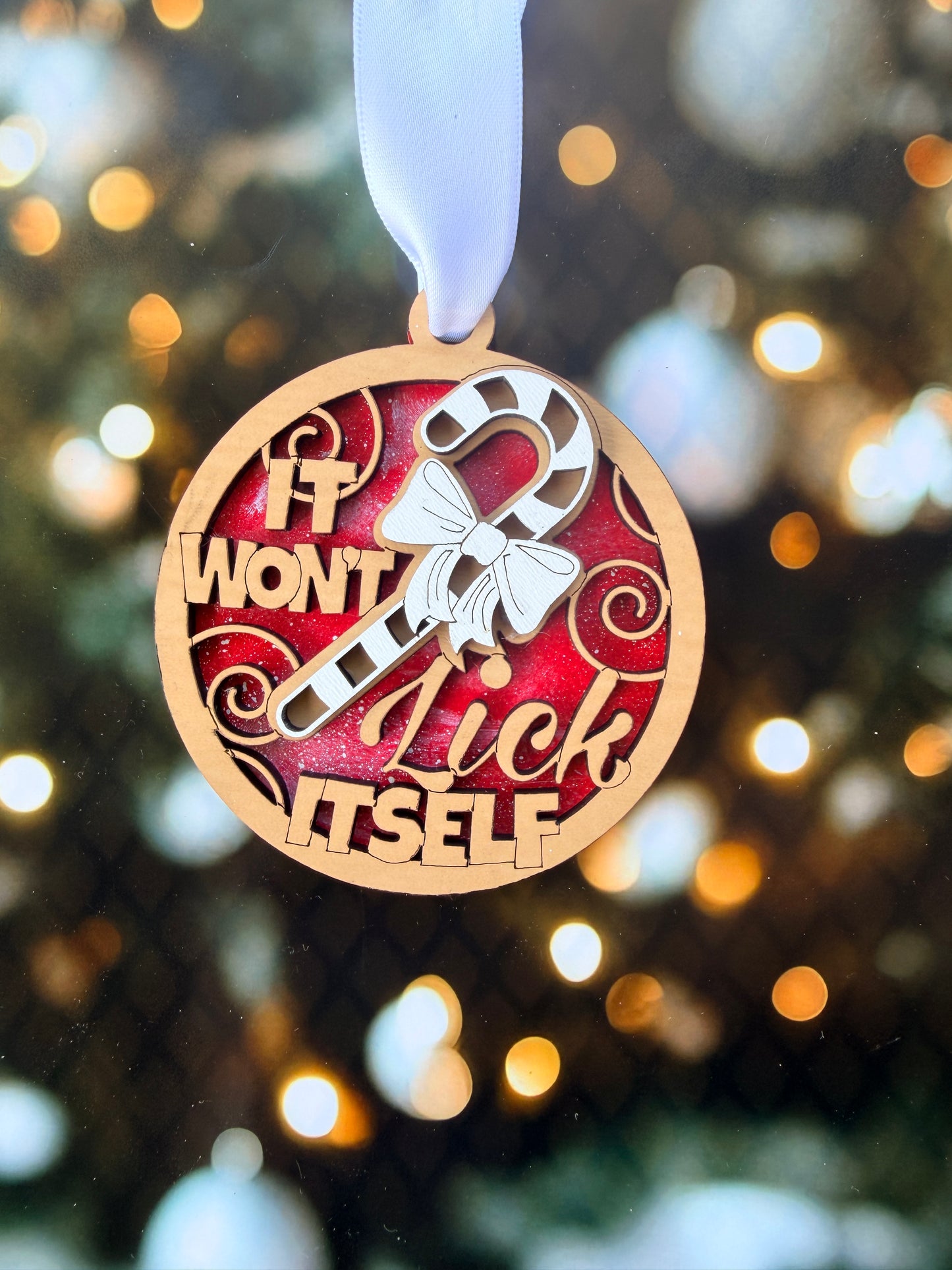 a christmas ornament hanging from a christmas tree