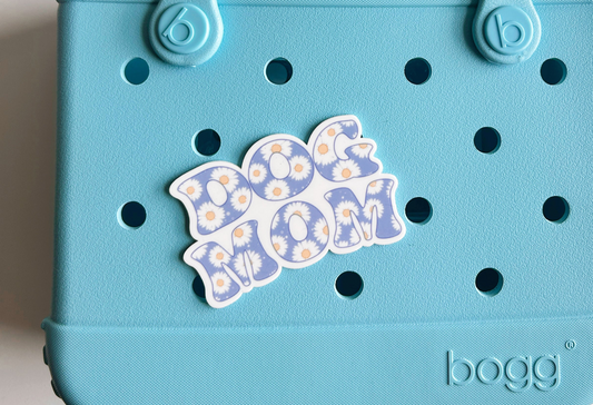 A light blue tote bag with a sticker on it.