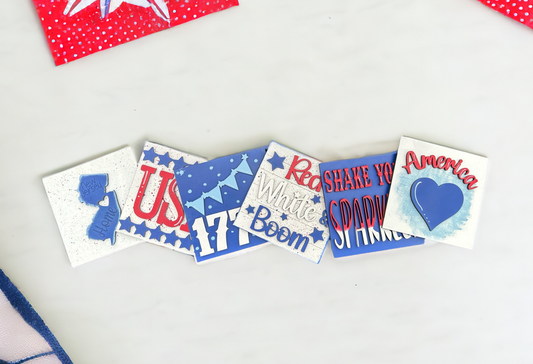 a white table topped with red, white and blue magnets
