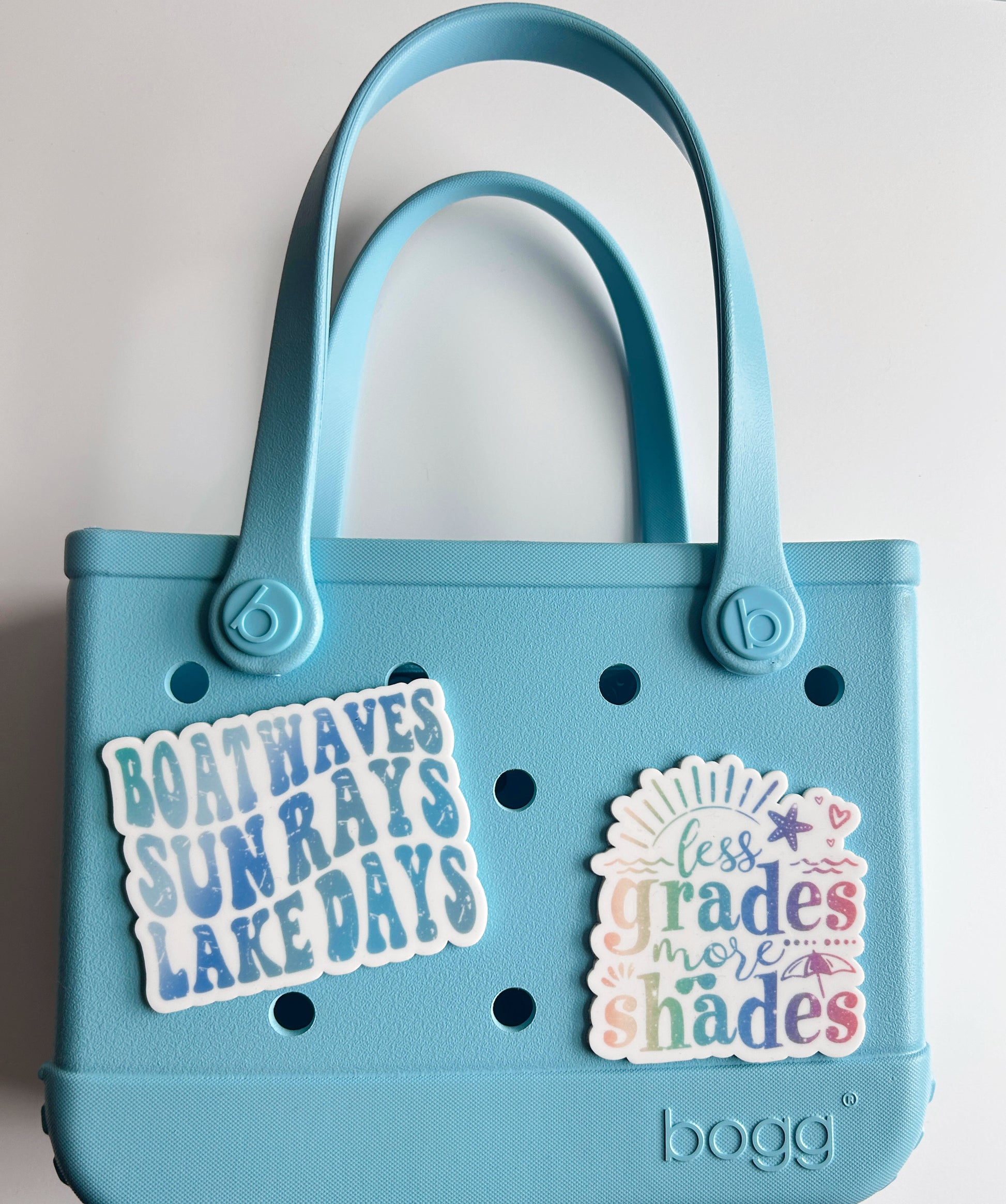 A light blue plastic tote bag with two stickers attached to it.