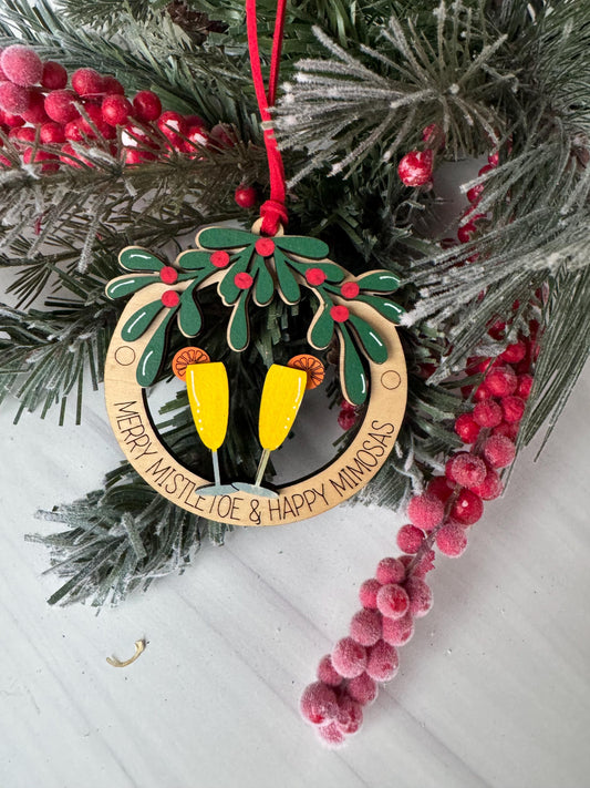 A festive Christmas wreath adorned with red berries, greenery, and a yellow ornament with a message.