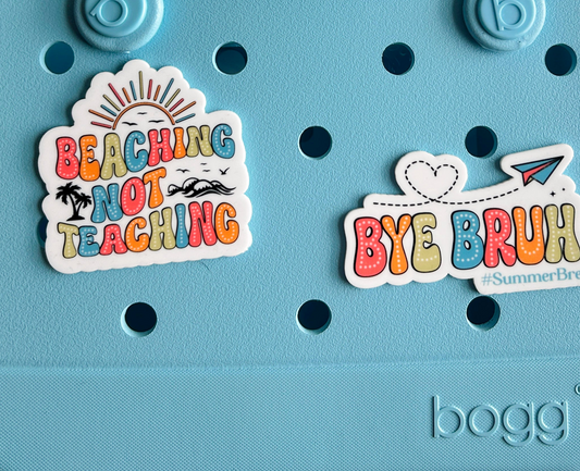 A light blue tote bag with various stickers and text on it.