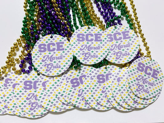 a bunch of purple and green tags on a white surface