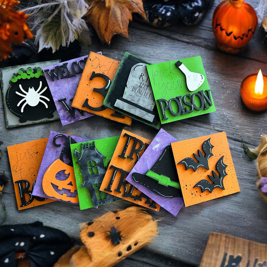 a pile of halloween cards sitting on top of a wooden table