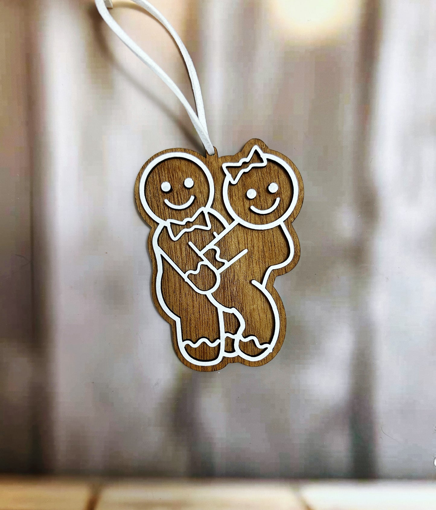 a wooden ornament with a couple holding each other