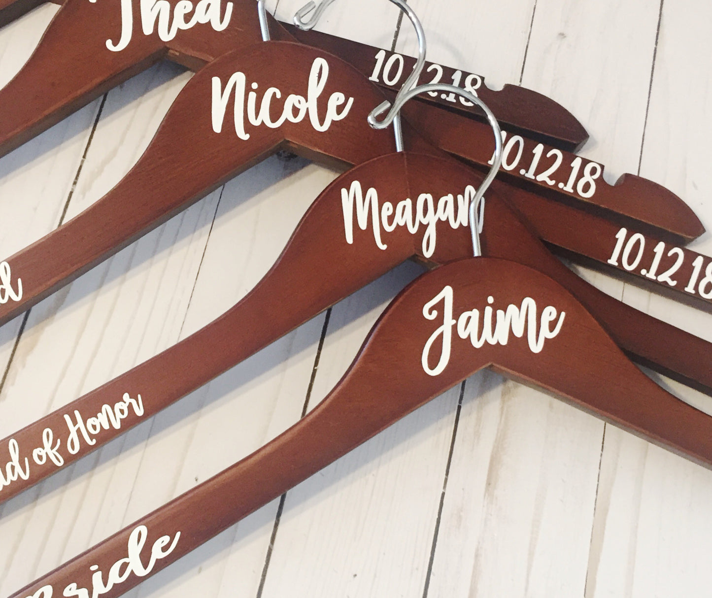 a group of wooden hangers with names on them