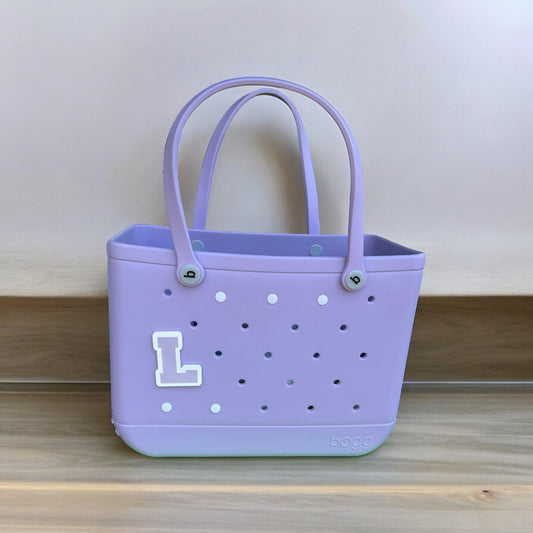 a purple purse with a white i on it