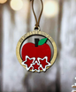 a christmas ornament with a red apple on it