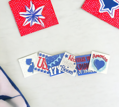 a white table topped with red, white and blue magnets