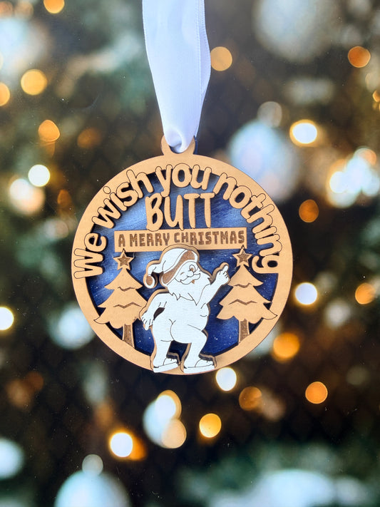 A wooden ornament with a blue background and a white ribbon, featuring a cartoon character and the text "You wish you nothing but a merry Christmas".