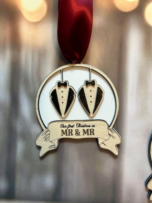 A wooden ornament with a ribbon and a banner that says "Our first Christmas as Mr & Mrs".