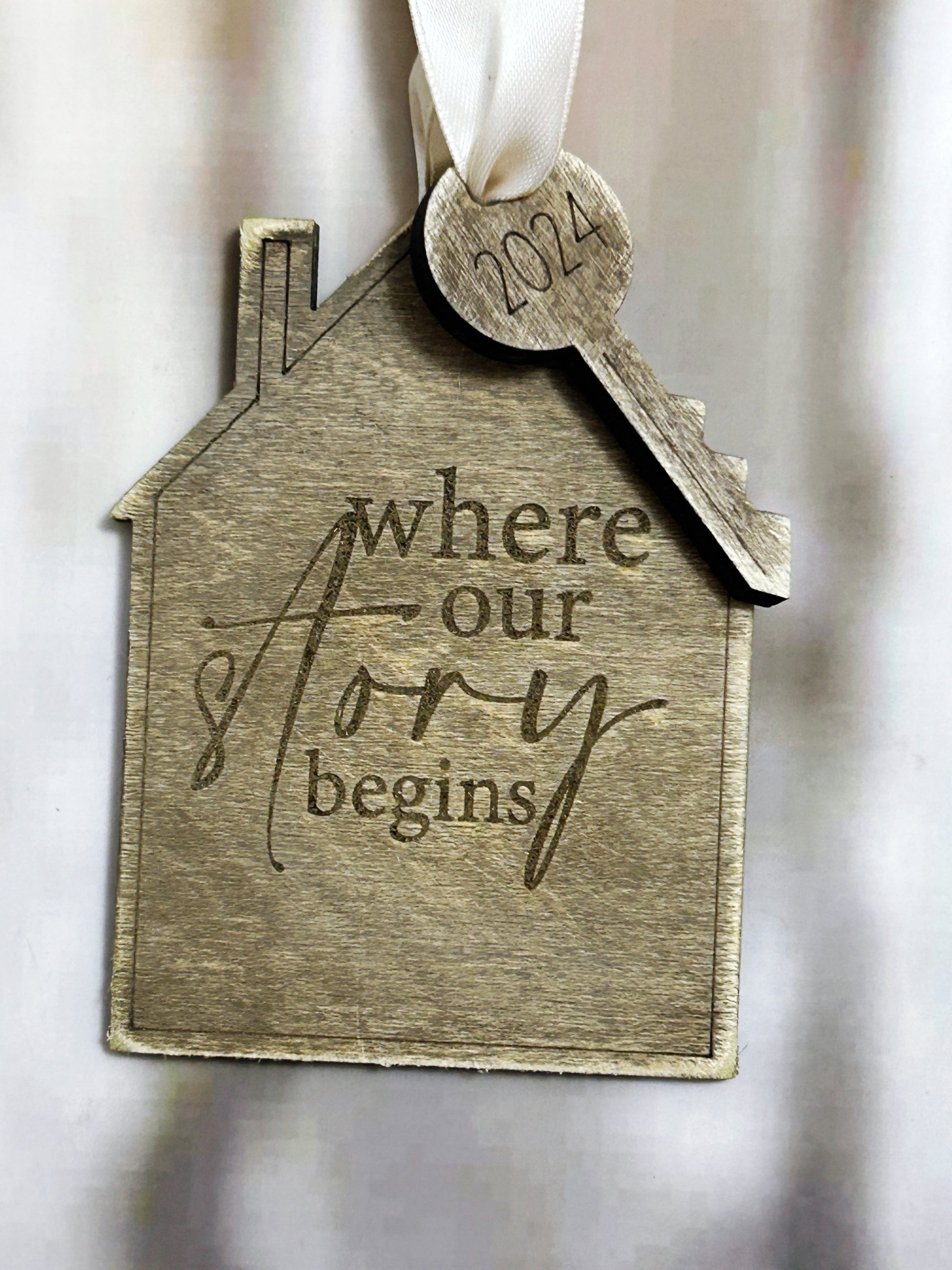 a house ornament with a key hanging from it