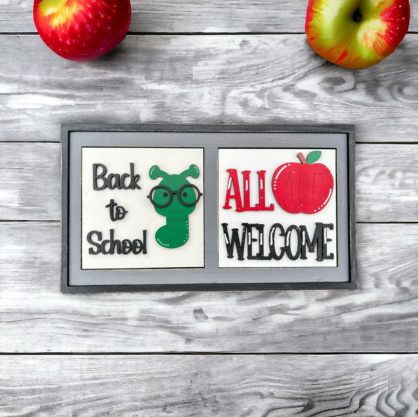 a picture of two apples and a sign that says back to school