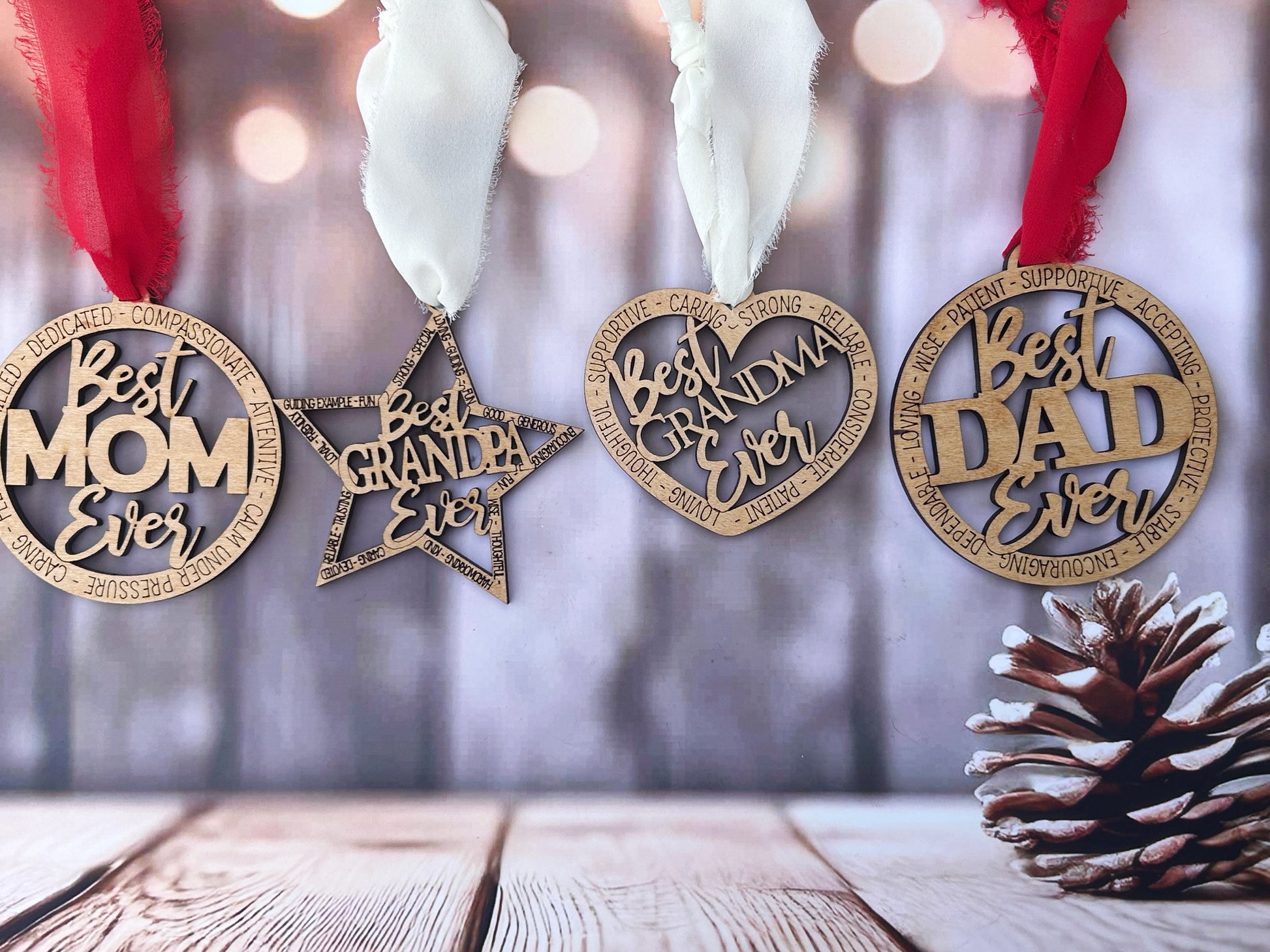 a set of wooden ornaments hanging on a wooden surface, with a pine cone placed to the right side.