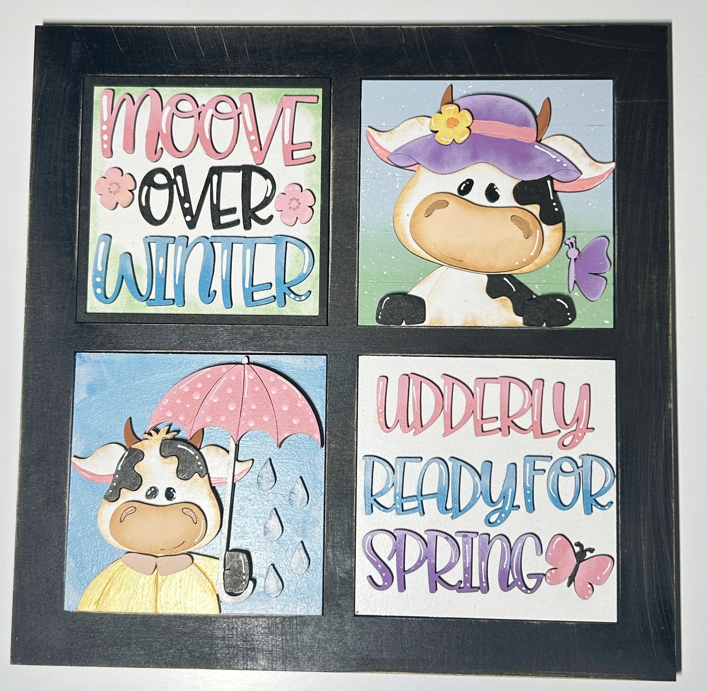 Framed artwork with cow illustrations and text on a white background


