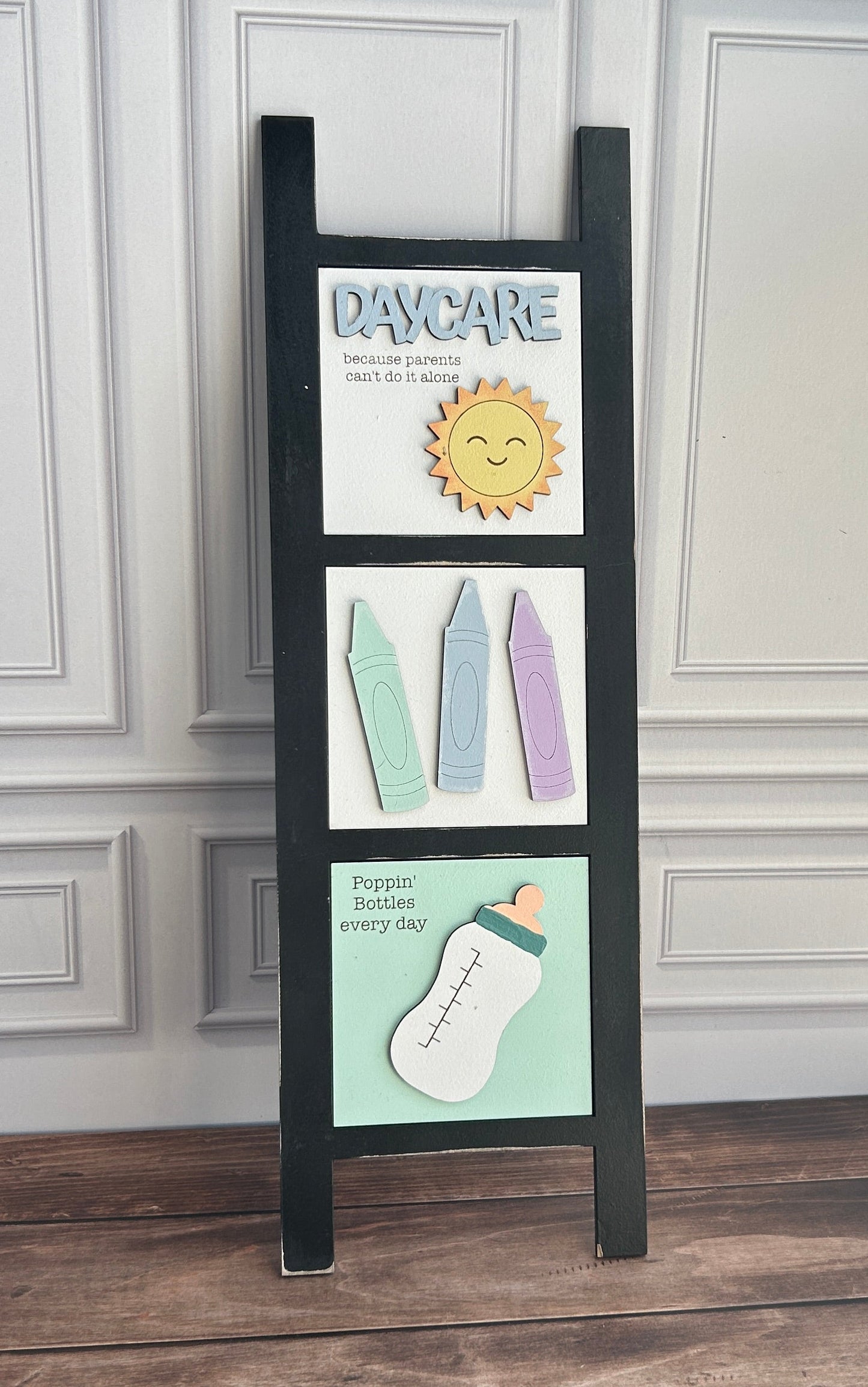 Decorative shelf with framed pictures against a white wall.