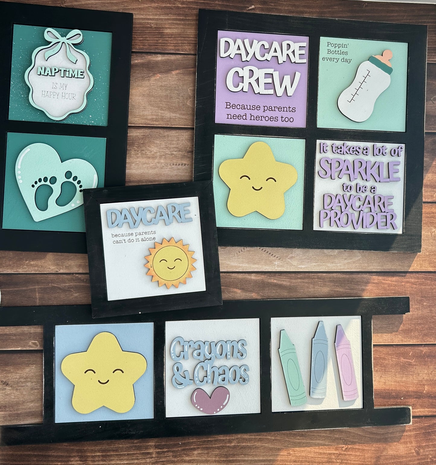 Set of daycare-themed decorative signs on a wooden surface