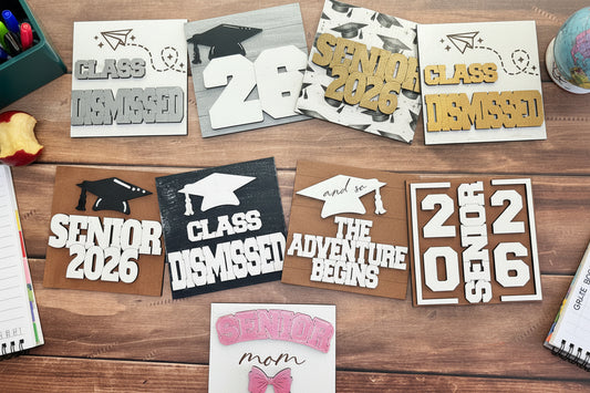 Collection of graduation-themed cutouts on a wooden surface