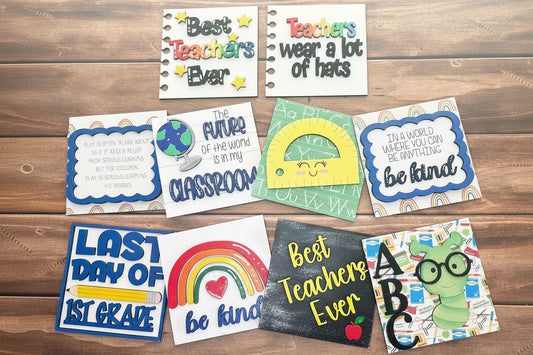 Collection of colorful educational-themed cards on a wooden surface