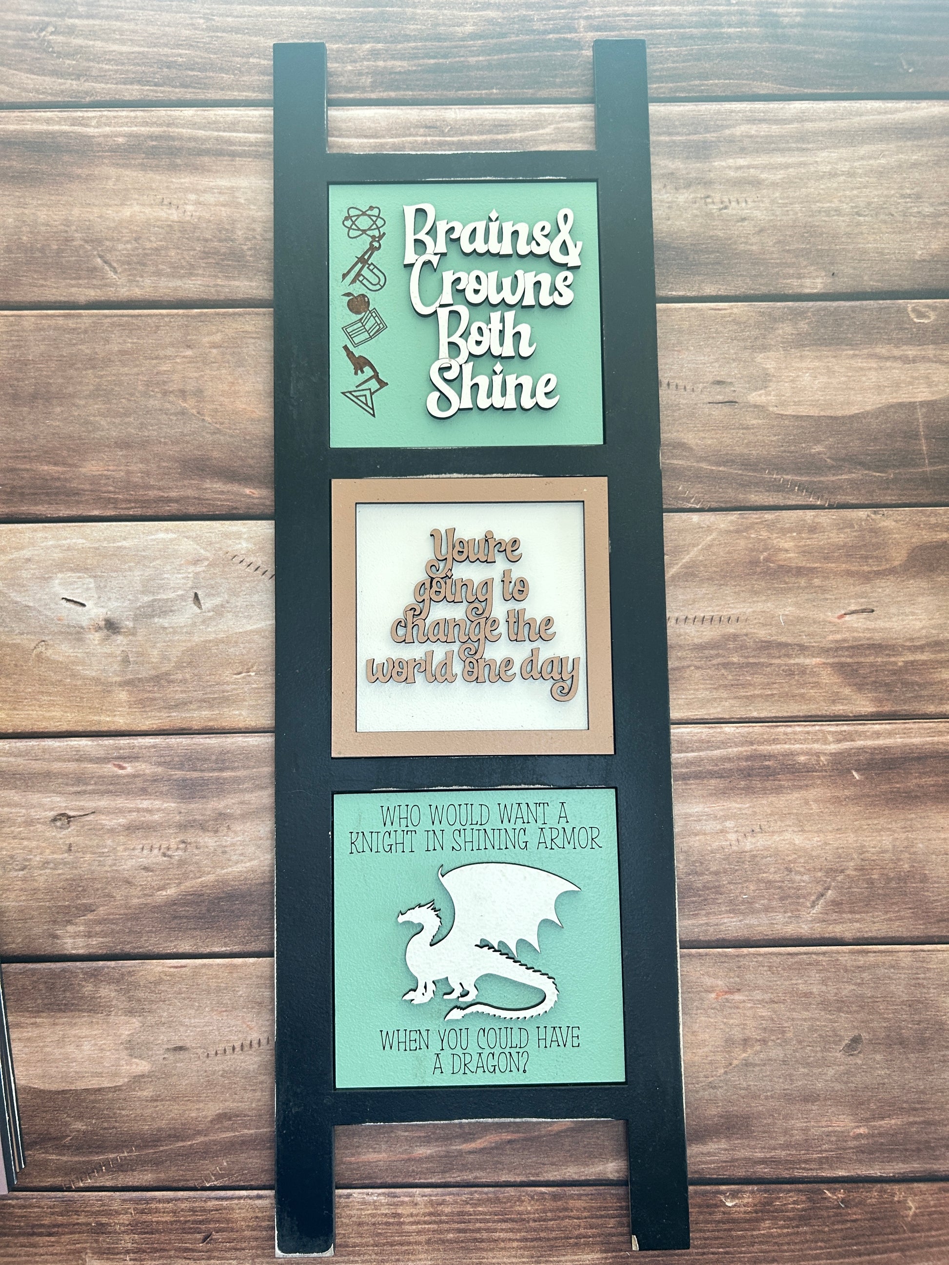 Decorative wall art with text and graphics on a wooden background