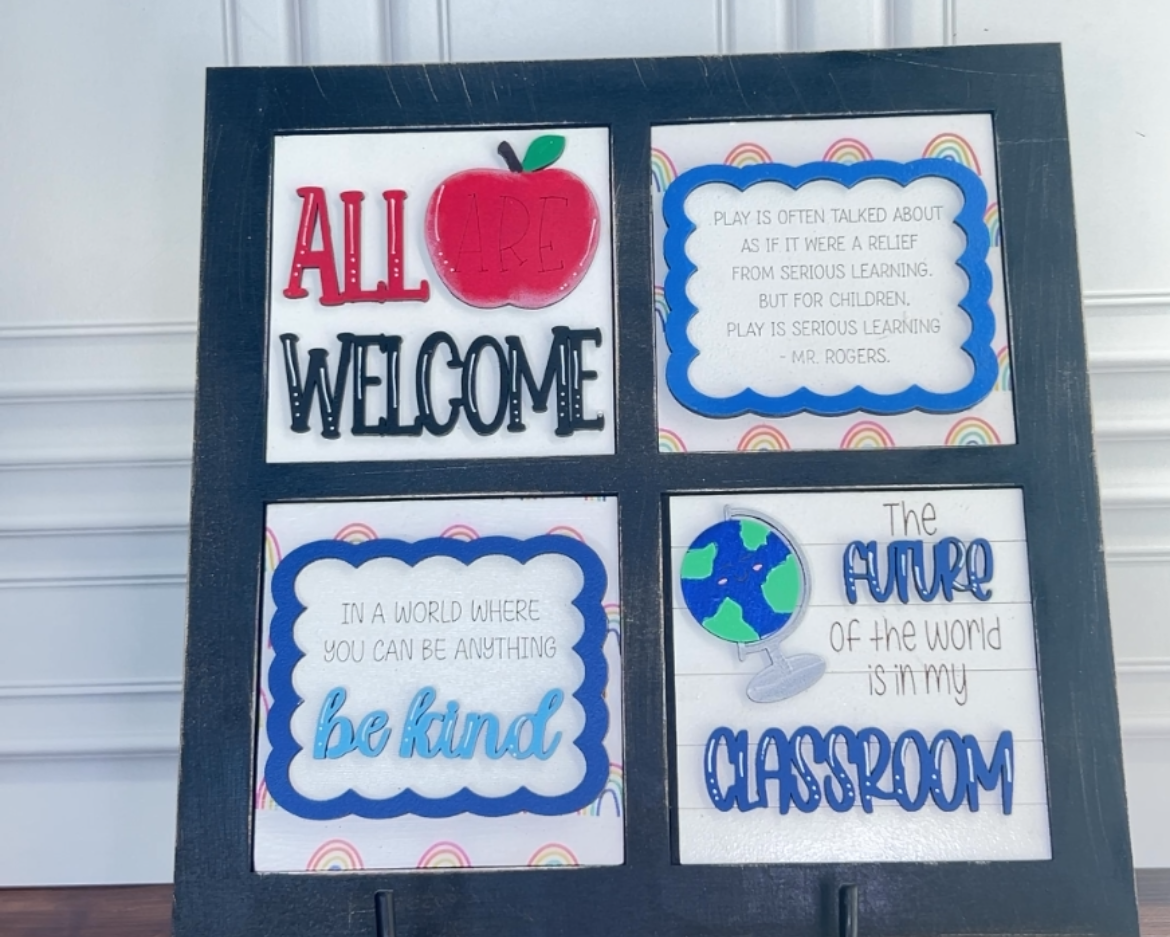 Decorative sign with educational-themed text and graphics on a stand.