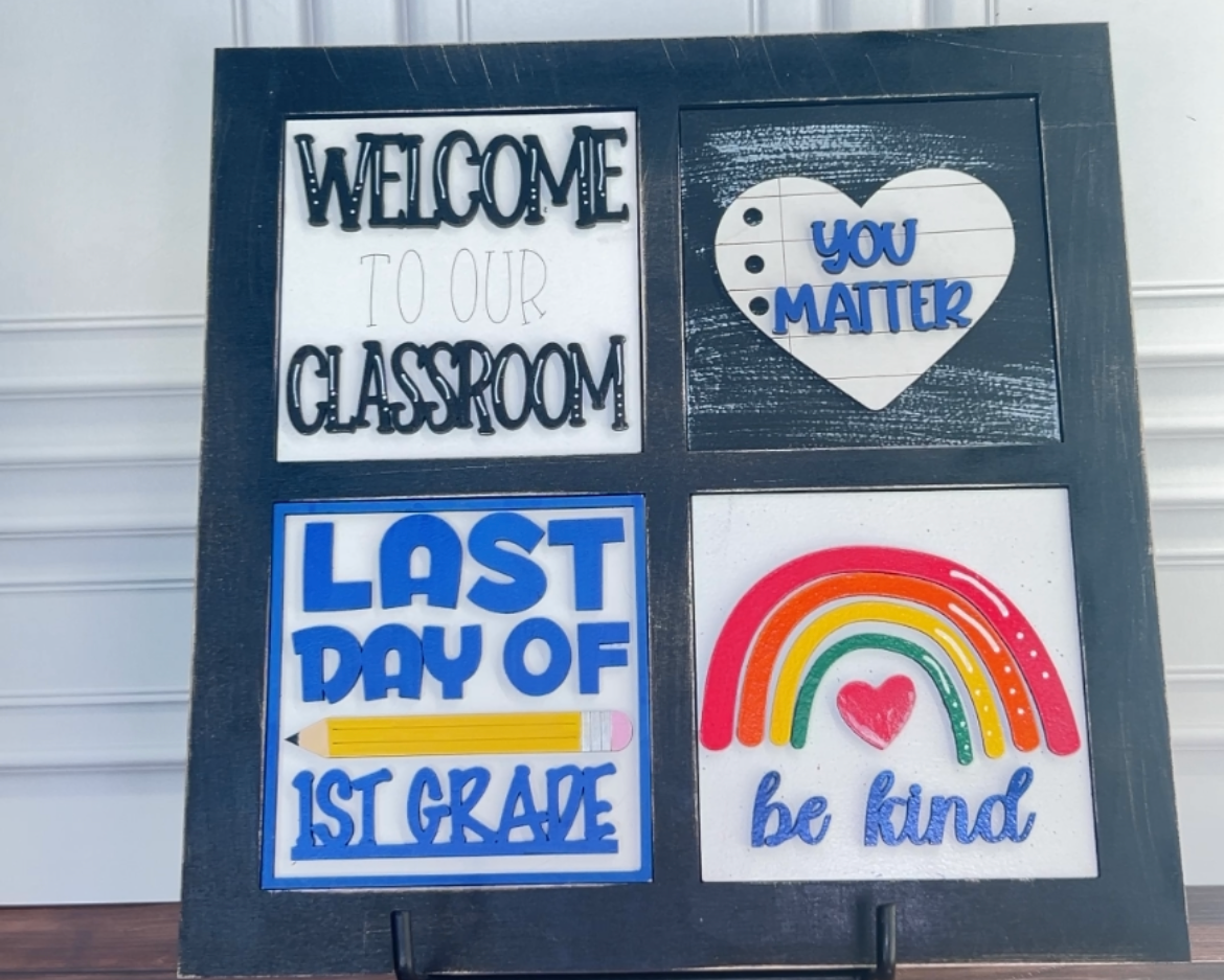 Decorative sign with educational phrases on a stand against a white wall.