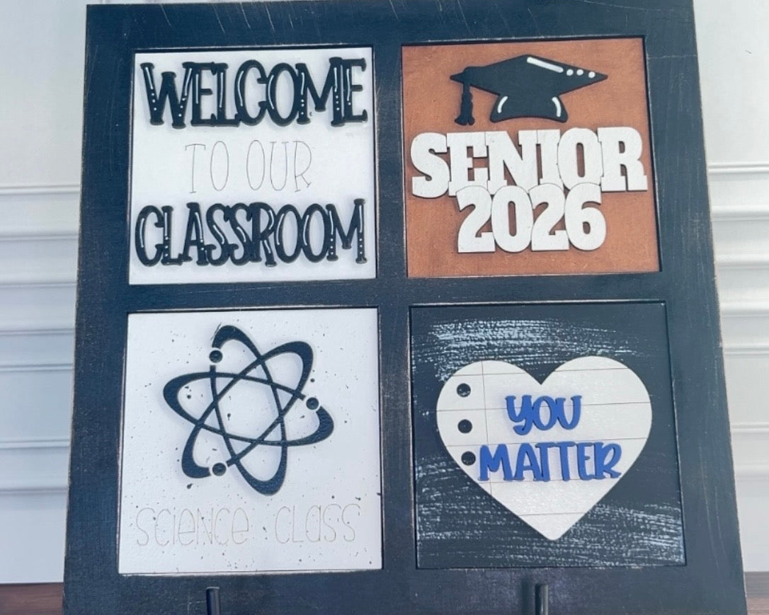 Decorative sign with educational-themed text on a stand against a white wall.