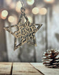 a wooden star ornament hanging from a wooden table