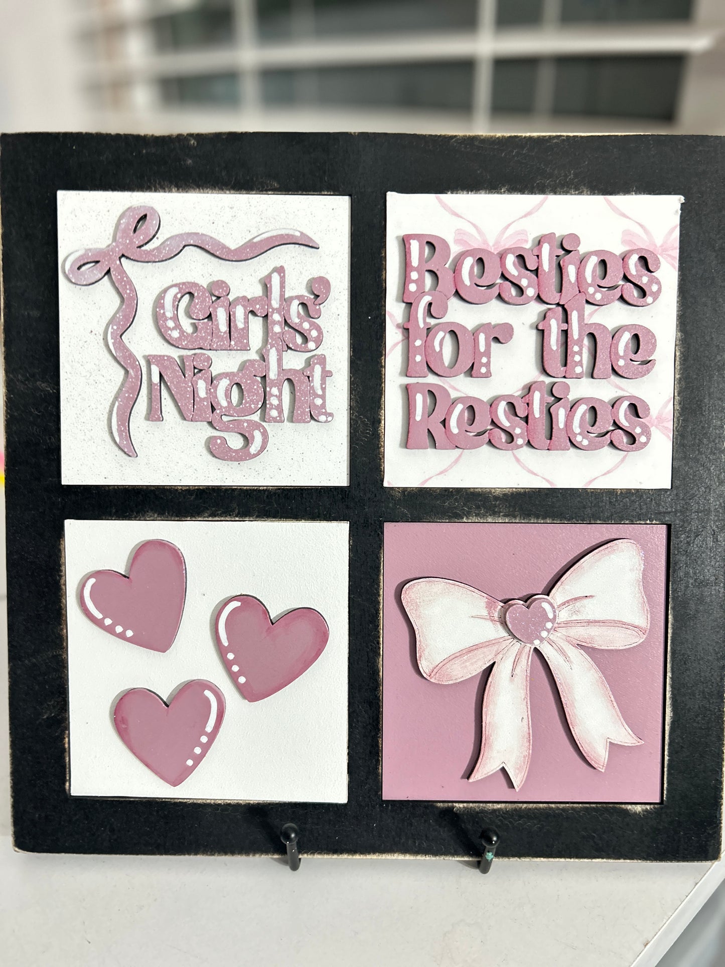 The image is a collage of four square images, each featuring a different design element. The first image is a white square with a pink ribbon and the text "Girls Night". The second image is a white square with three pink hearts. The third image is a pink square with a bow. The fourth image is a pink square with a heart and a bow.
