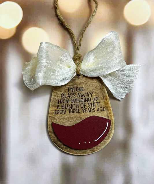 a wooden ornament hanging from a string