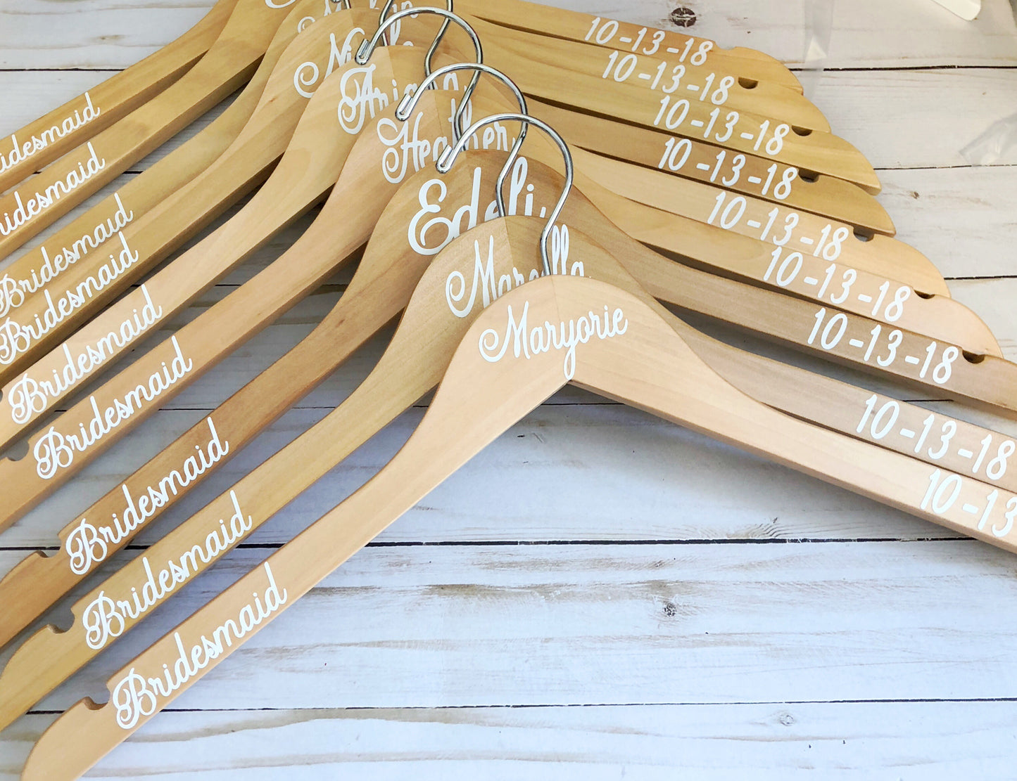 a bunch of wooden hangers with names on them