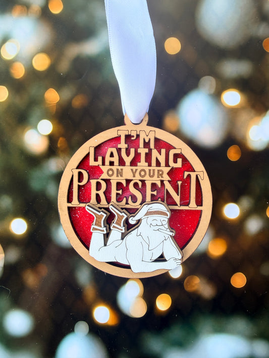 A wooden medal with a red background and a white ribbon, featuring a cartoon character and the text "Playing on Our Own"