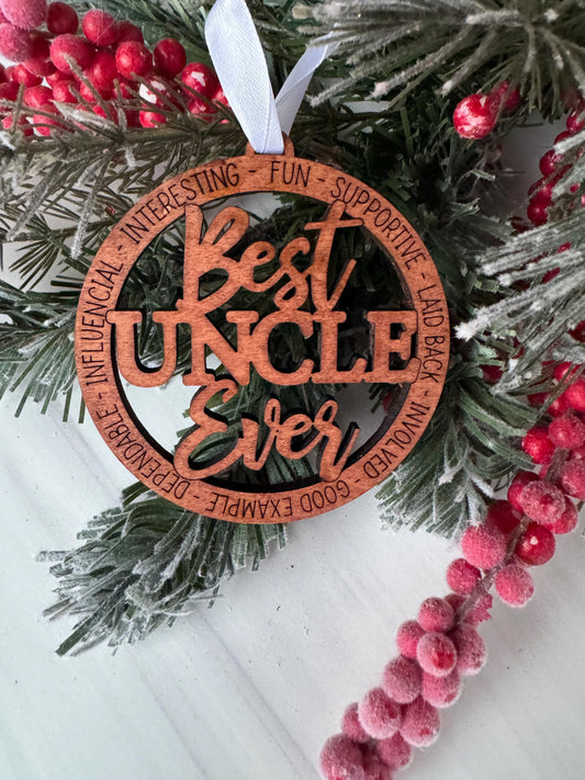 A wooden ornament with the text &quot;Best Uncle Ever&quot; carved into it, surrounded by pine branches and red berries.