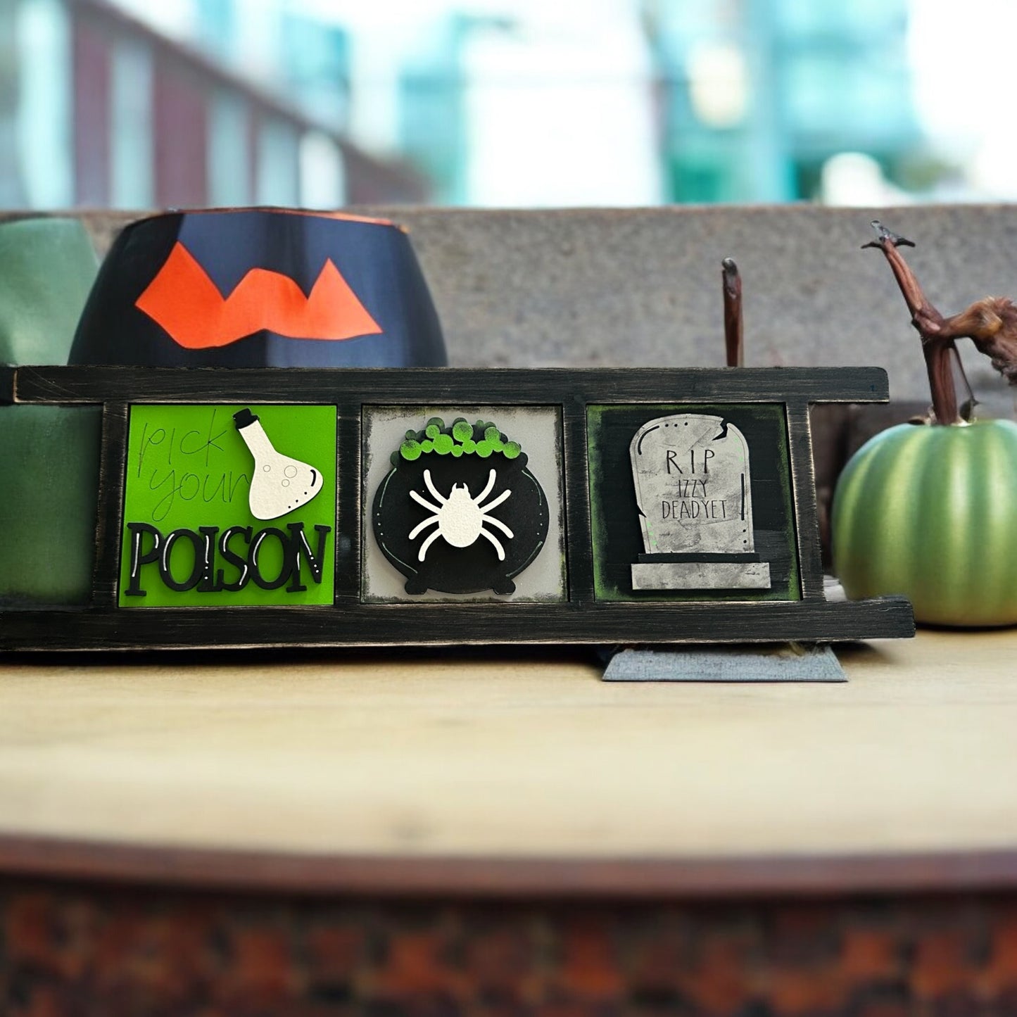 a picture frame with a picture of a spider, a pumpkin, and a ghost