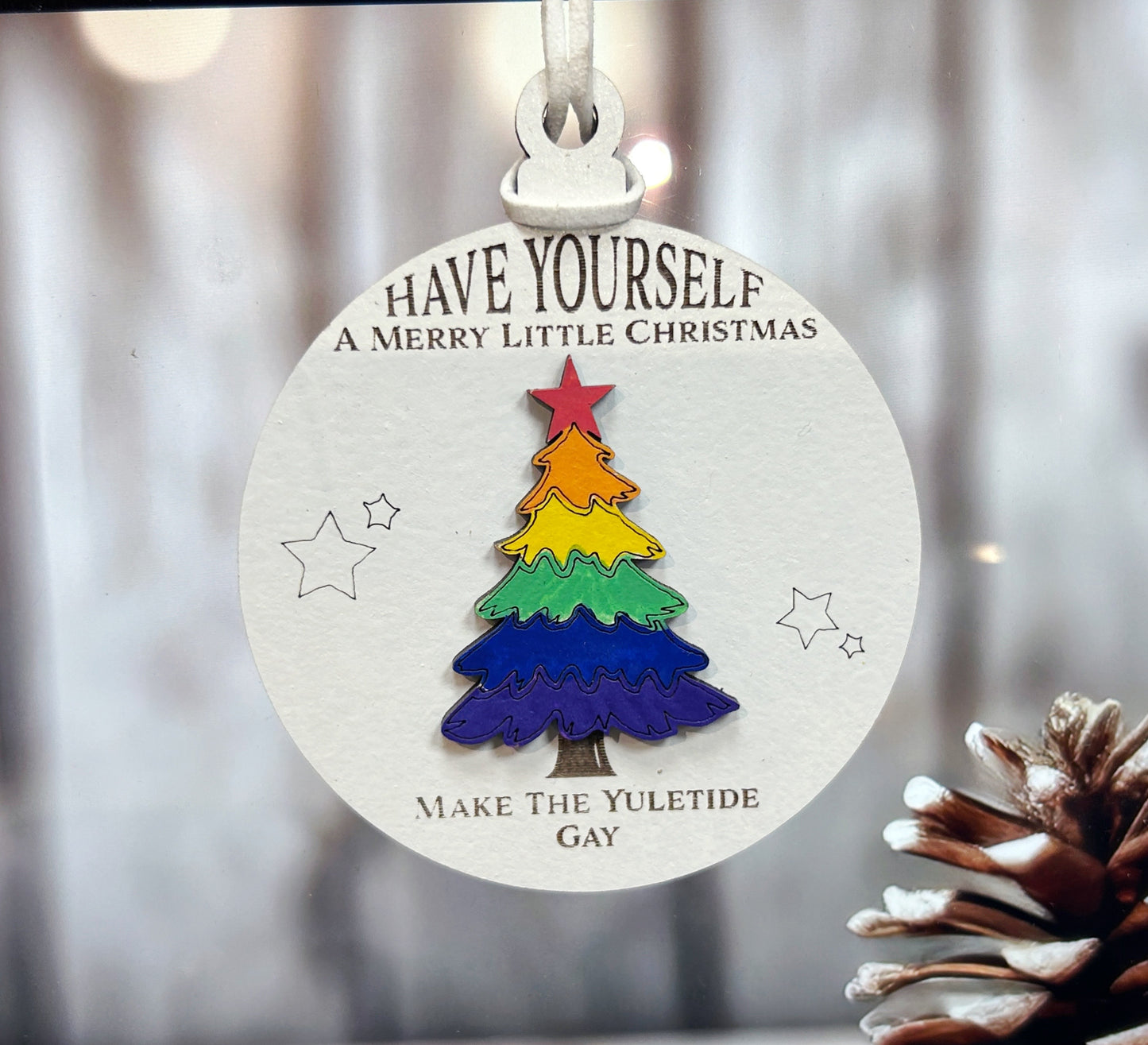 a christmas tree ornament hanging from a window