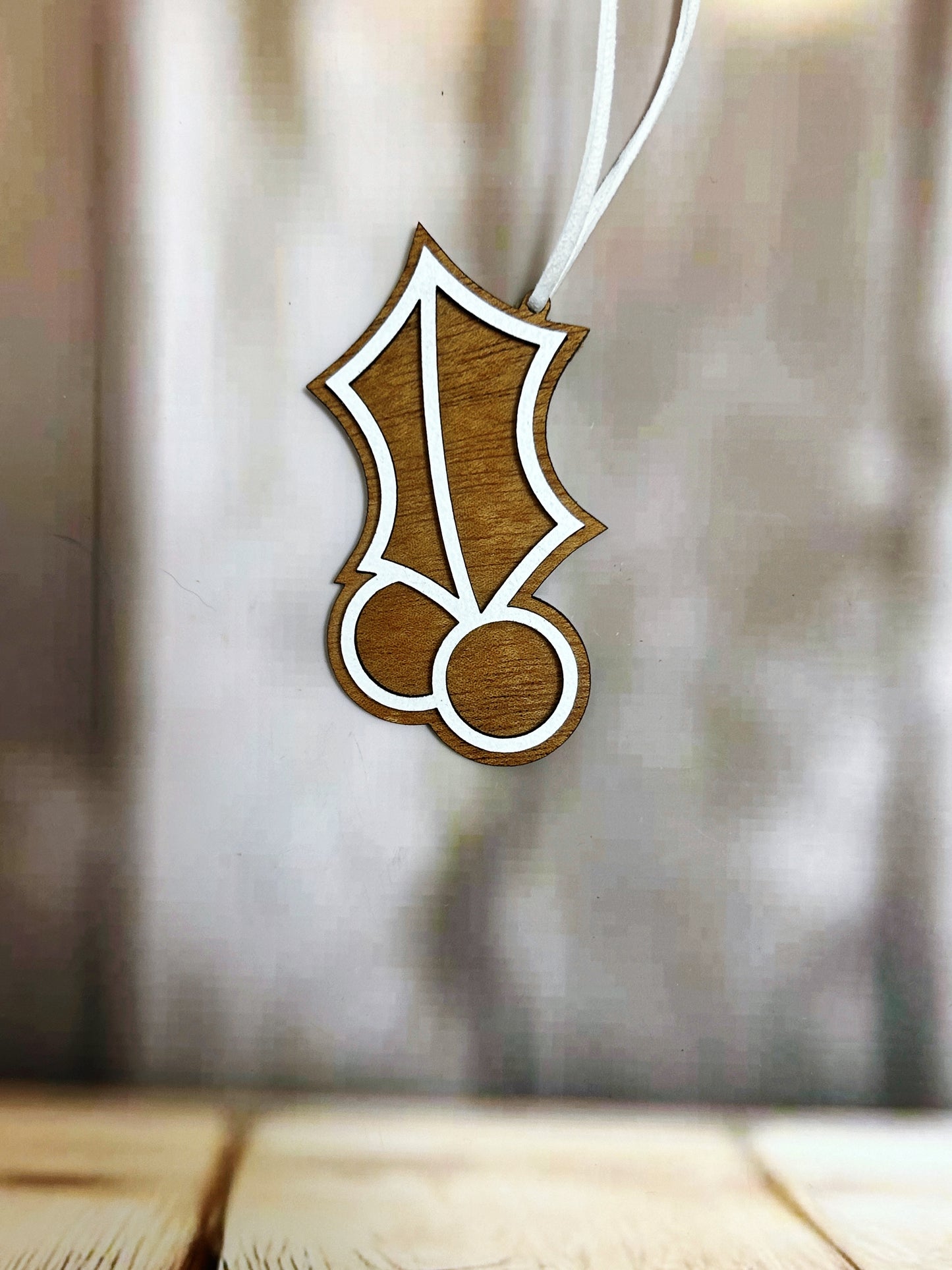 a wooden ornament hanging from a string