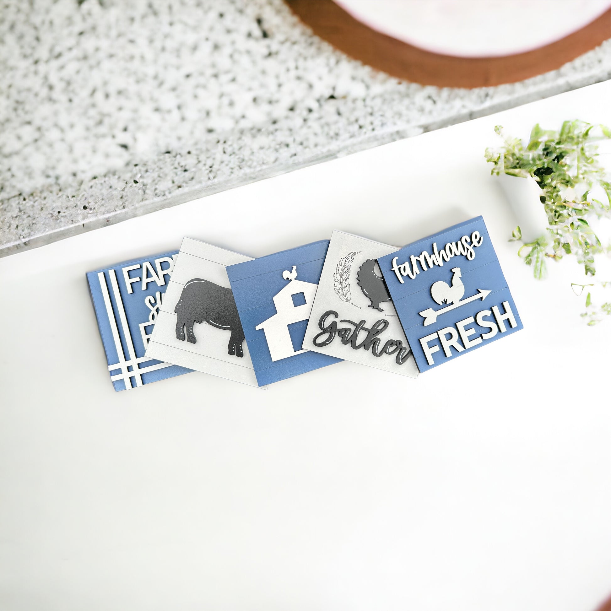 a white table topped with cards and a potted plant