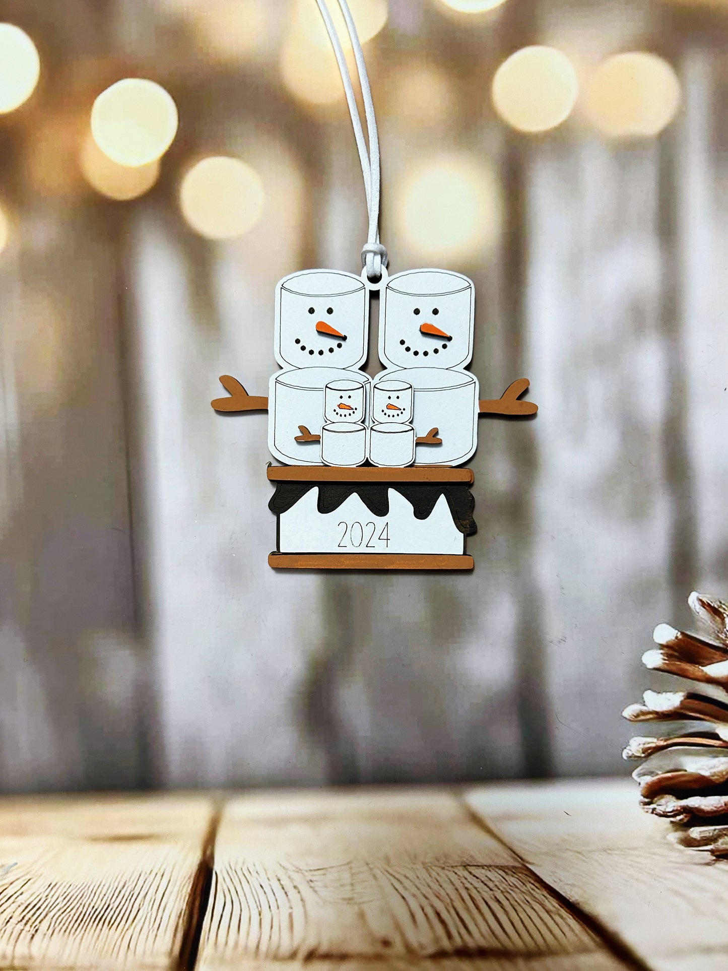 a christmas ornament hanging from a wooden table