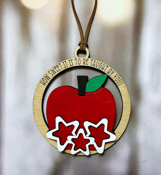 a christmas ornament with a red apple on it