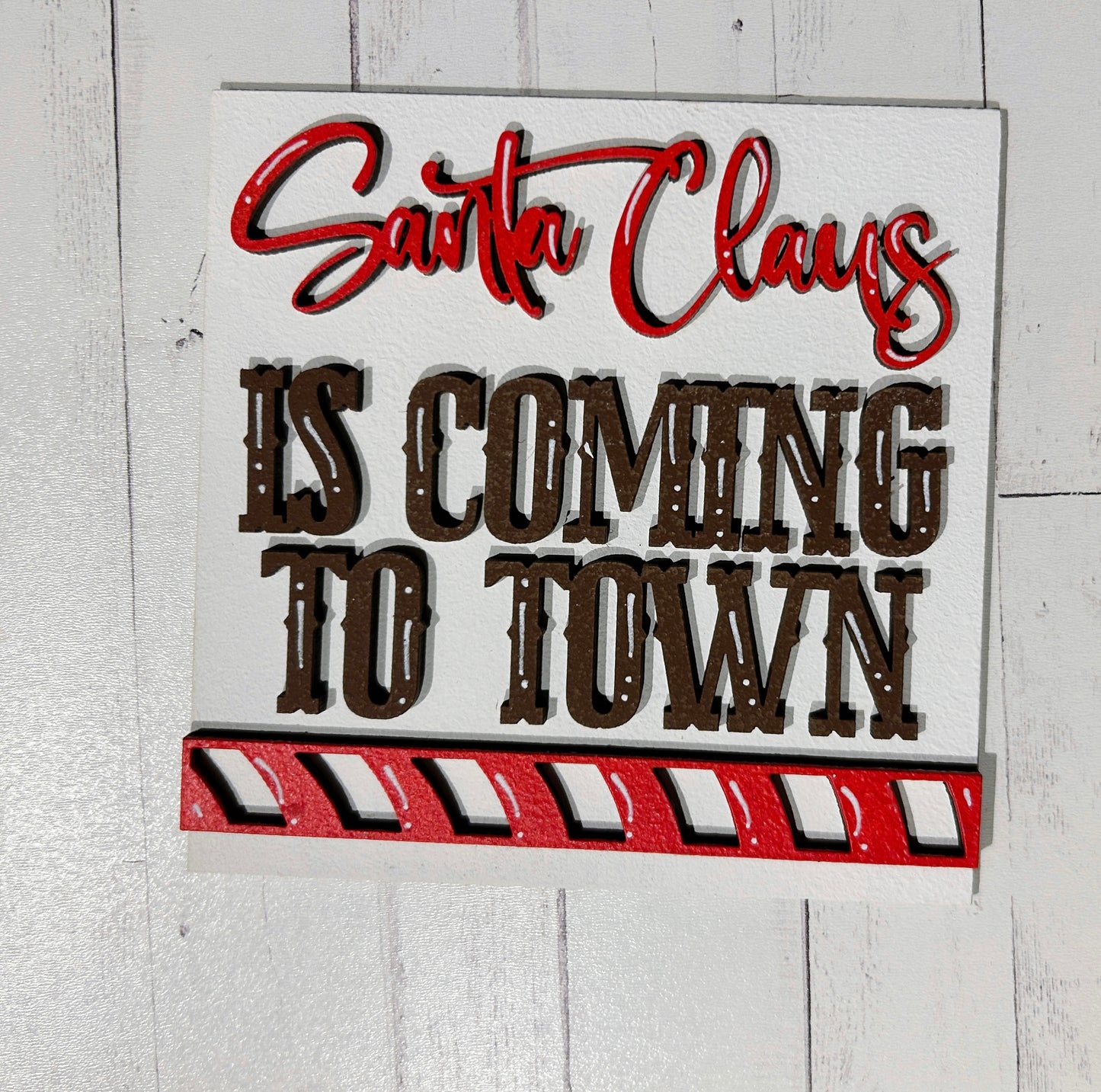 a sign that says santa claus is coming to town