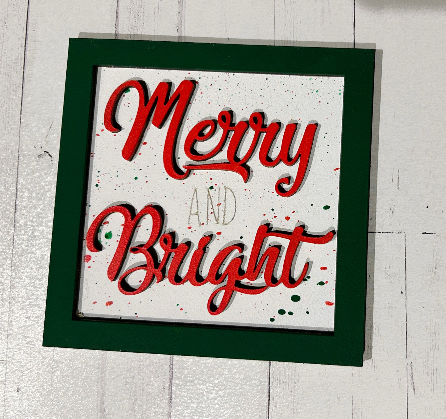 a merry and bright christmas card hanging on a wall