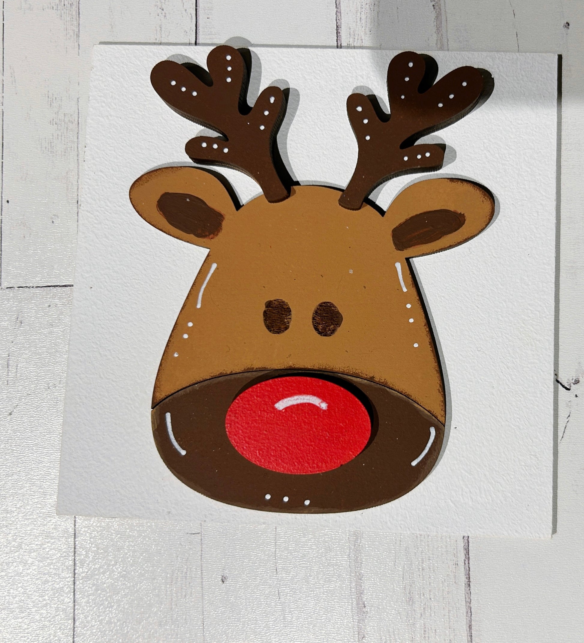 a picture of a reindeer with a red nose